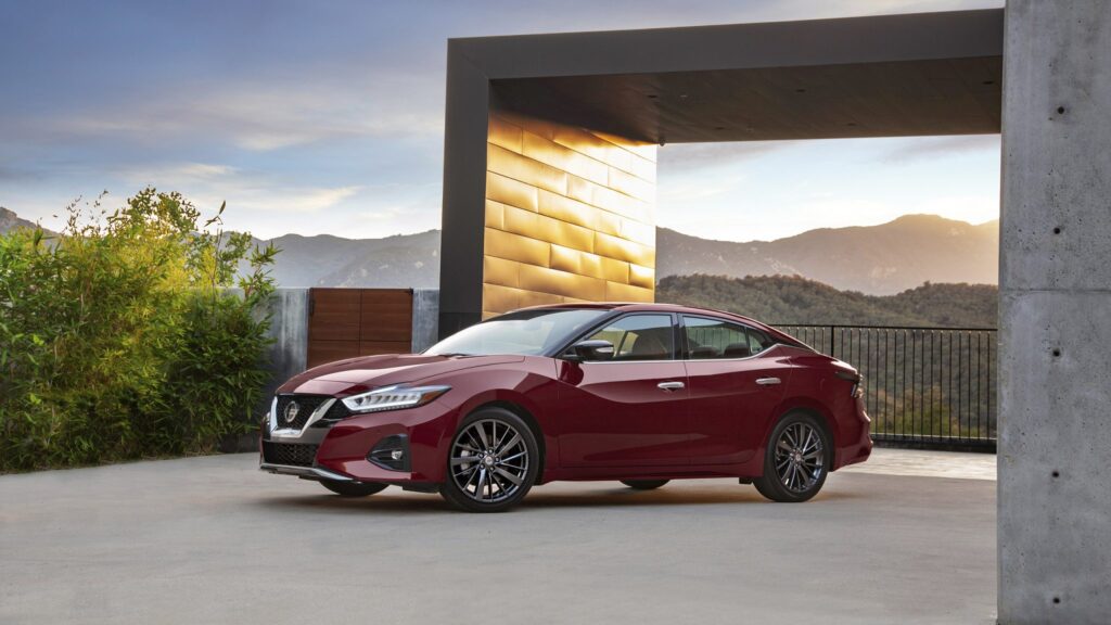 Three-quarter side angle of a 2023 red Nissan Maxima